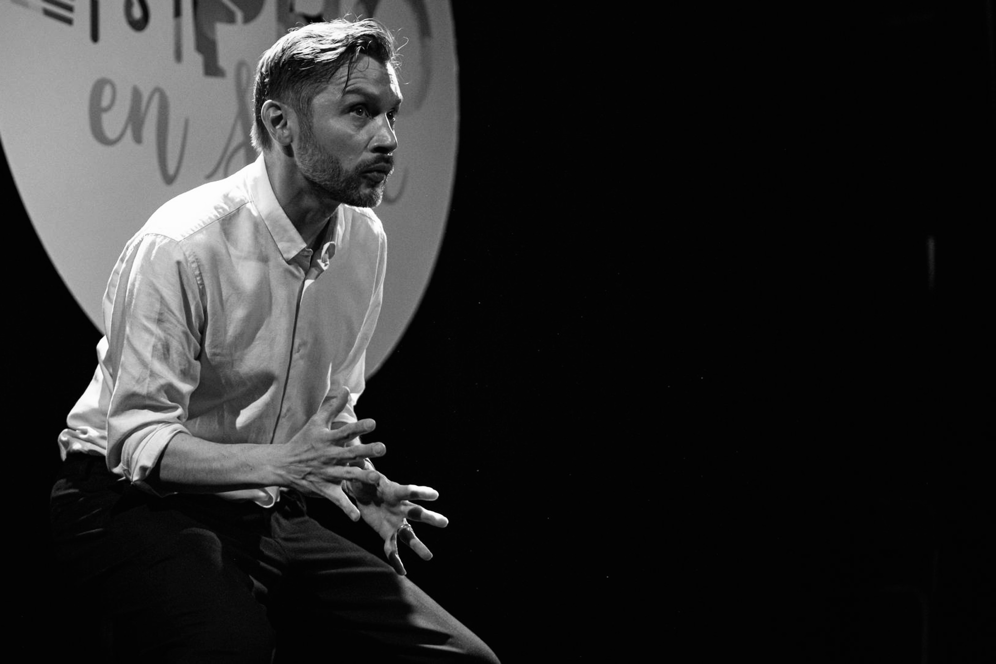 Caspar Schjelbred performing The Supreme Art of Improvisation, crouched low with cupped hands, caught mid-impulse